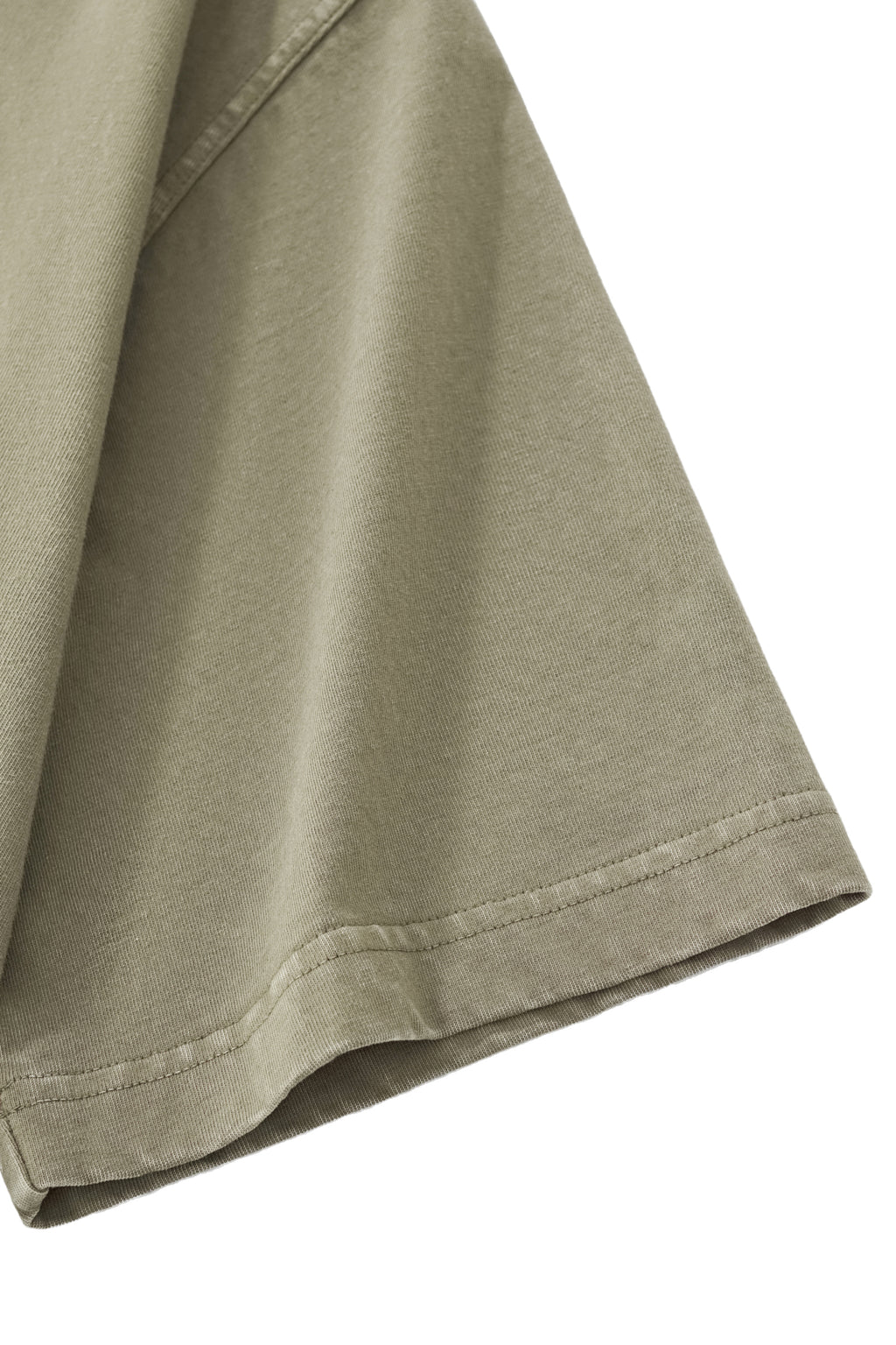 Close-up of the Trini Born Culture Tee Arrival Edition sleeve showing clean double-stitched hems and premium heavyweight 100% cotton fabric. Oversized boxy fit Caribbean streetwear built for everyday comfort and durability