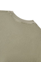Back neckline detail of the Trini Born Culture Tee Arrival Edition highlighting reinforced ribbed collar construction, premium heavyweight cotton fabric, and quality craftsmanship designed for lasting wear.