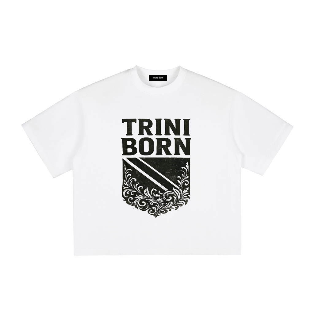 Trini Born Culture Tee Arrival Edition in white with bold black Trinidad-inspired crest graphic. Premium heavyweight cotton oversized boxy fit unisex Caribbean fashion celebrating Trinidad and Tobago heritage
