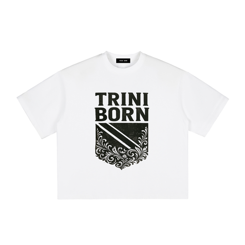 Trini Born Culture Tee Arrival Edition in white with bold black Trinidad-inspired crest graphic. Premium heavyweight cotton oversized boxy fit unisex Caribbean fashion celebrating Trinidad and Tobago heritage