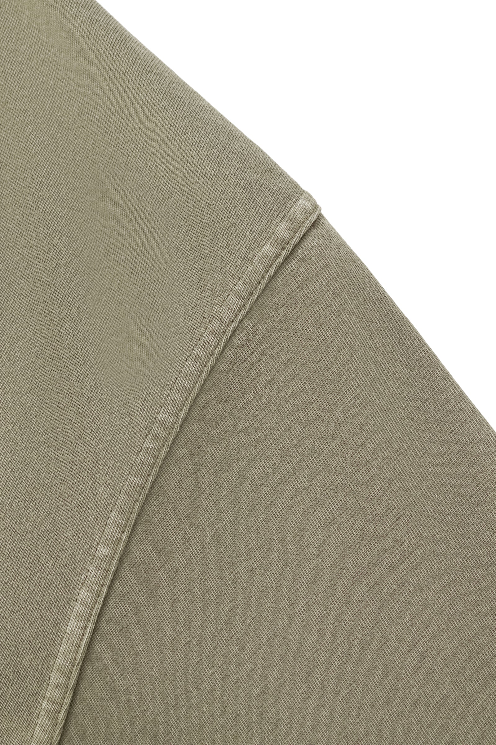 Detailed view of the Trini Born Culture Tee Arrival Edition shoulder seam highlighting premium stitching, heavyweight cotton construction, and oversized boxy fit inspired by modern Caribbean fashion.