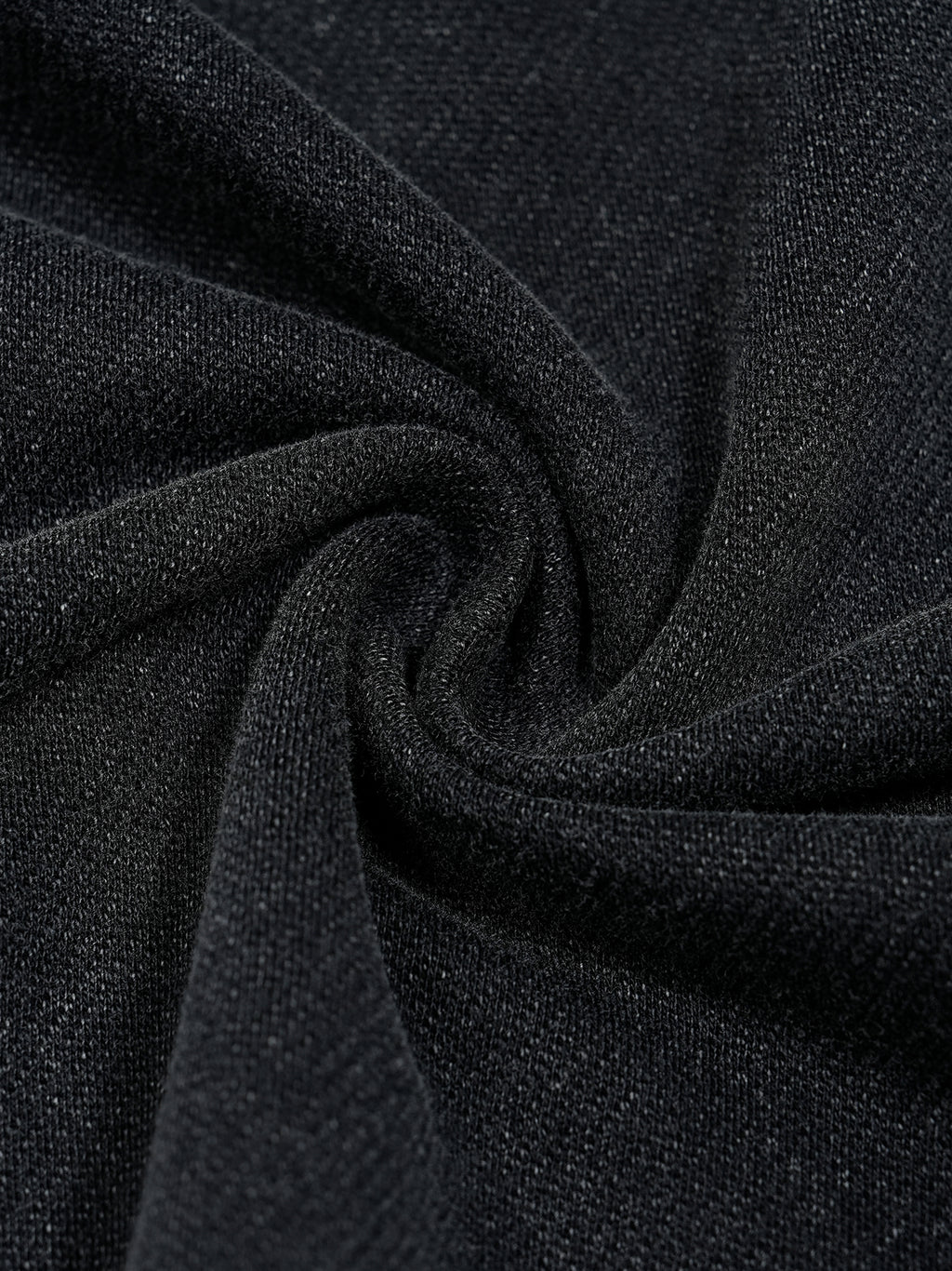 Close up of washed black 100 percent cotton fabric from Trini Born Culture Tee showing soft premium knit texture