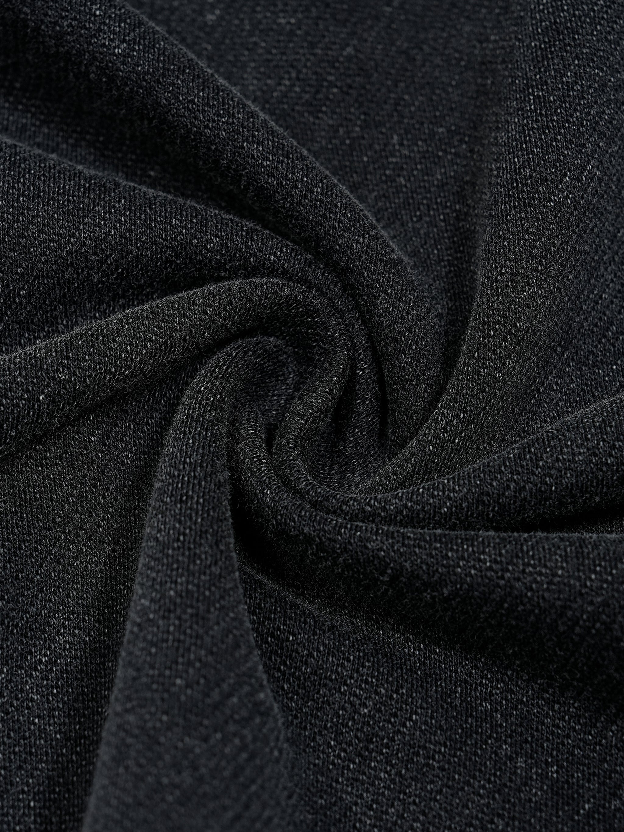 Close up of washed black 100 percent cotton fabric from Trini Born Culture Tee showing soft premium knit texture