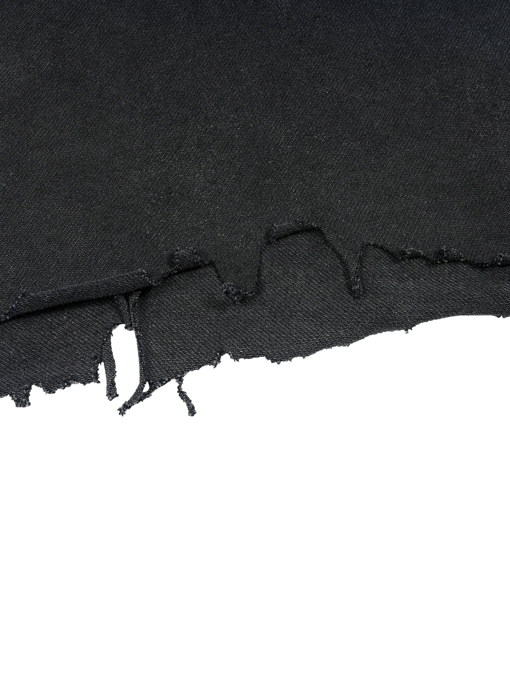Raw distressed hem detail on washed black Trini Born Culture Tee showing hand cut edge and frayed finish