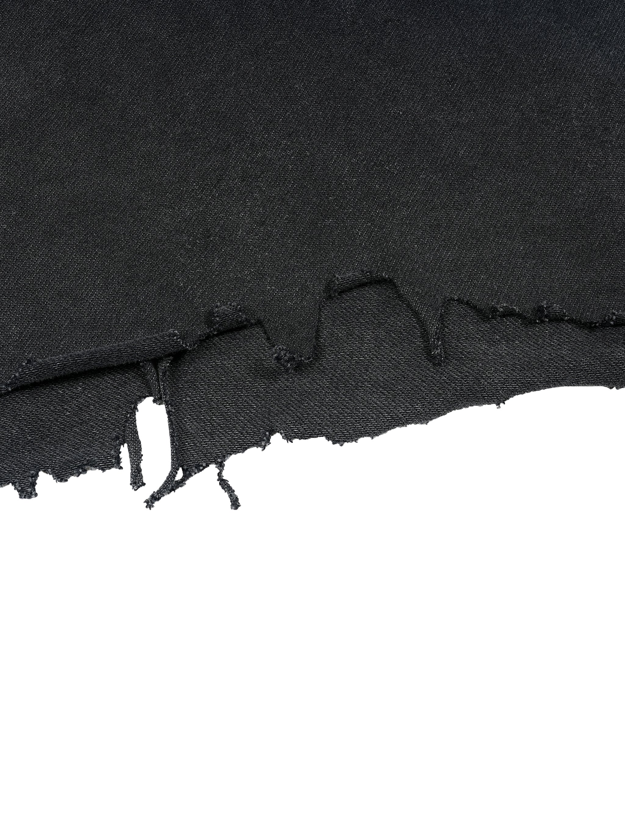 Raw distressed hem detail on washed black Trini Born Culture Tee showing hand cut edge and frayed finish