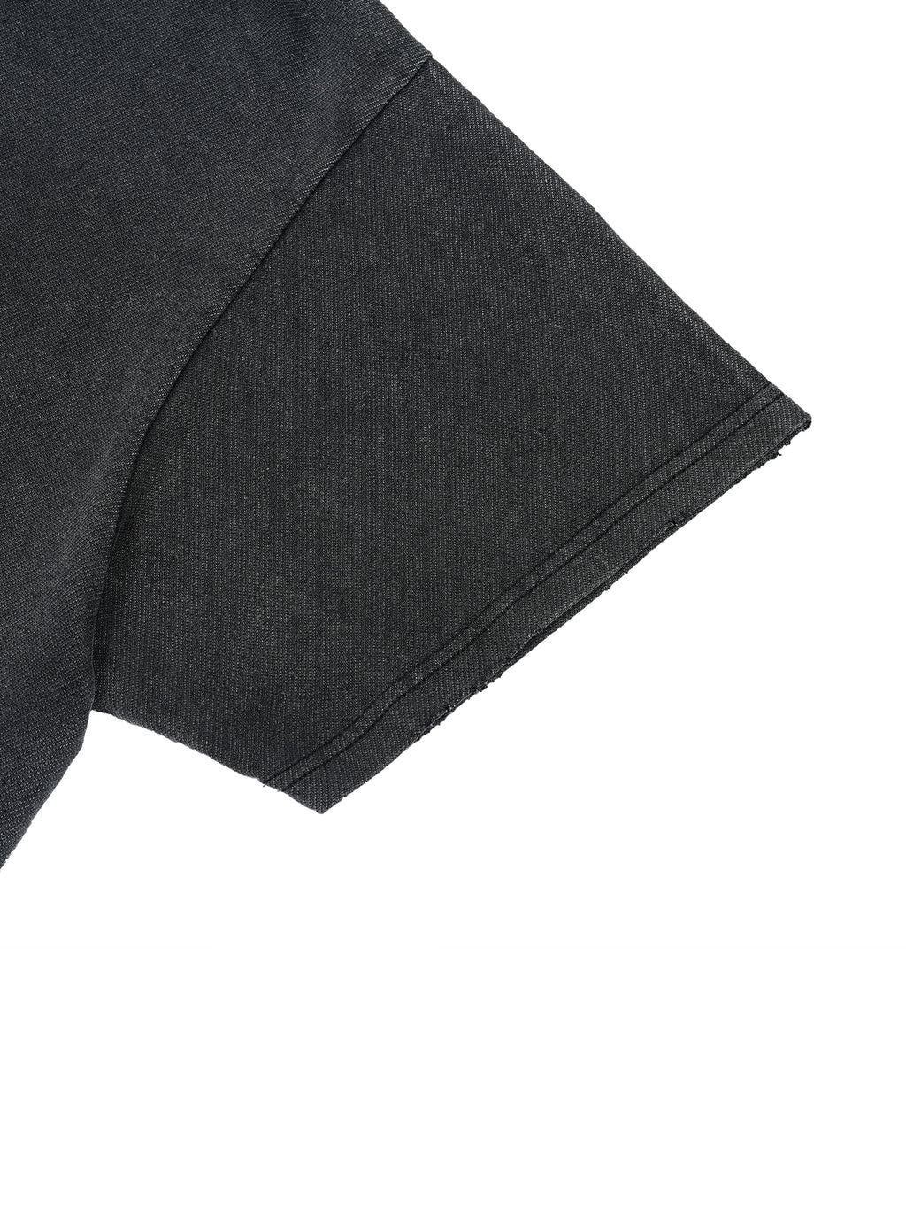 Short sleeve detail on washed black Trini Born Culture Tee showing thick premium cotton and double stitched hem
