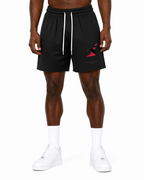 Trini Born black mesh shorts on model, back view with subtle Trini Born script detail.