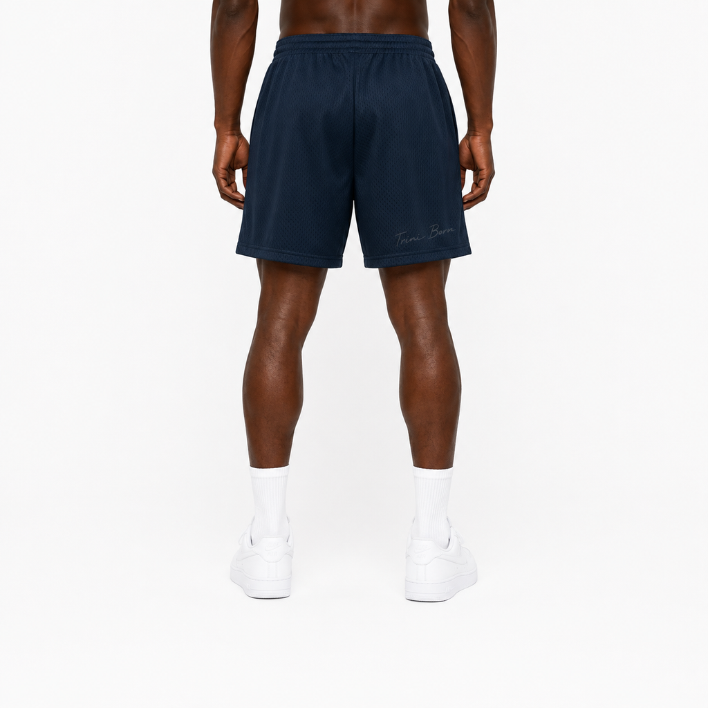 Trini Born navy mesh shorts on model, back view with subtle Trini Born script detail.