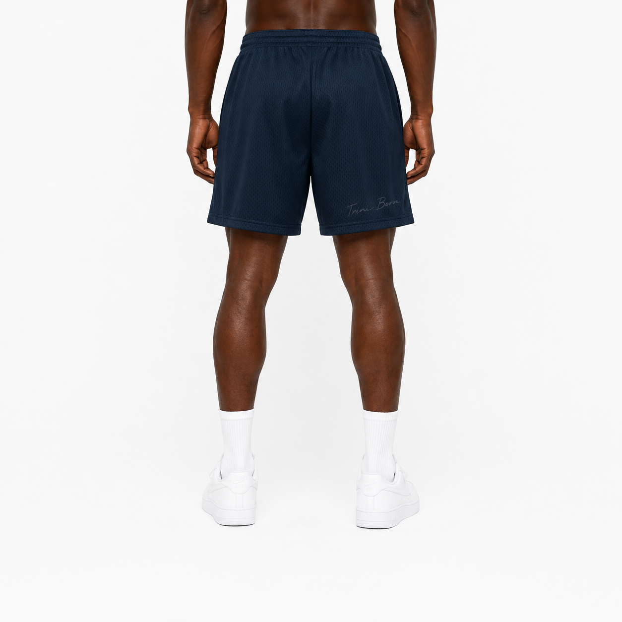 Trini Born navy mesh shorts on model, back view with subtle Trini Born script detail.