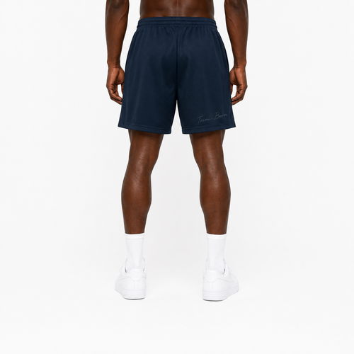 Trini Born navy mesh shorts on model, back view with subtle Trini Born script detail.