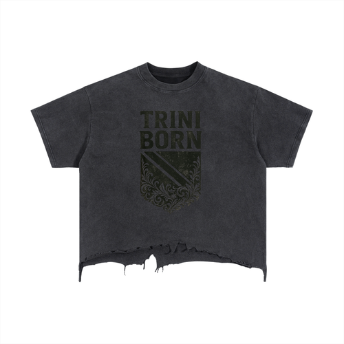 Trini Born Culture Tee in washed black front view, oversized cropped Trinidad streetwear shirt with crest graphic and raw hem