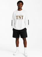 Black male model wearing the Trini Born Steelpan Heritage oversized long sleeve in oat gray, front view with Established in TNT, TNT and The Steel Pan graphics.