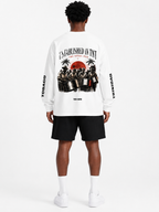 Black male model wearing the Trini Born Steelpan Heritage oversized long sleeve in white, front view with Established in TNT, TNT and The Steel Pan graphics.